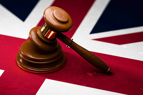 A gavel resting on a Union Jack