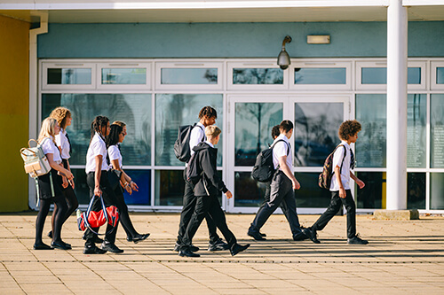 A group of school children entering their school