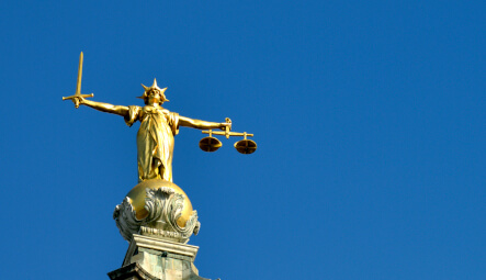 Lady Justice against a blue sky