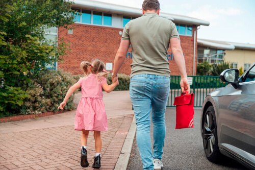 dad taking daughter to school