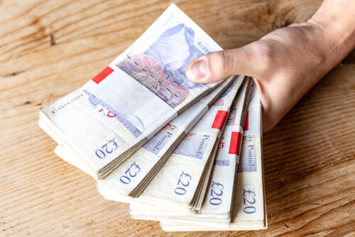 £20 notes in a hand