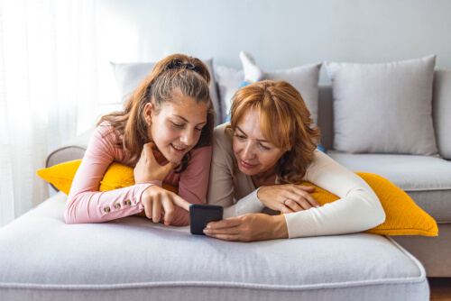 mother and daughter looking at phone