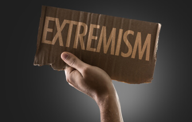 hand holding up extremism sign