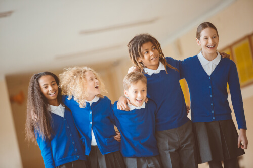 happy school children in school corridor