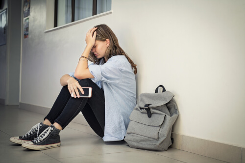 Upset student sat in school corridor