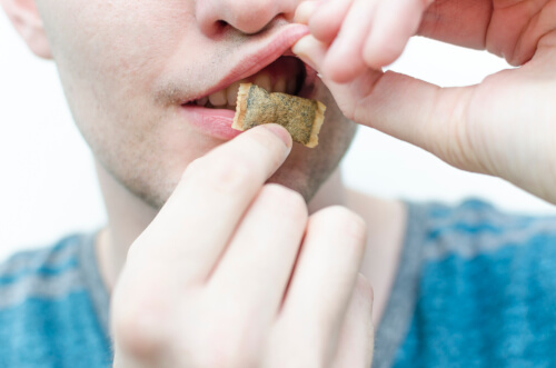 Young man using snus