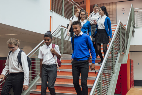 School pupils walking down stairs