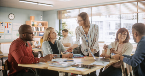 Professionals discussing around a desk